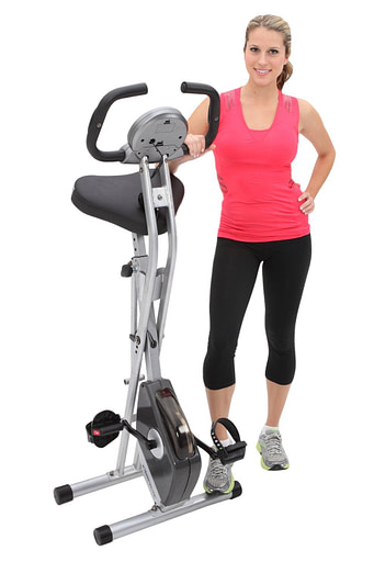 female standing by the best folding exercise bike