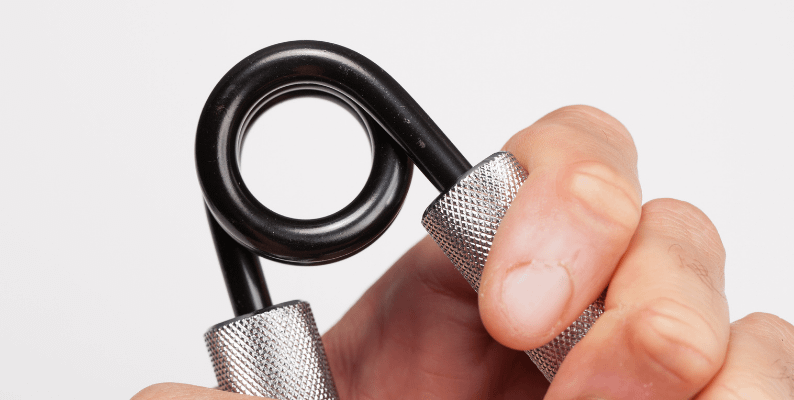 man using metal hand grippers for exerciise